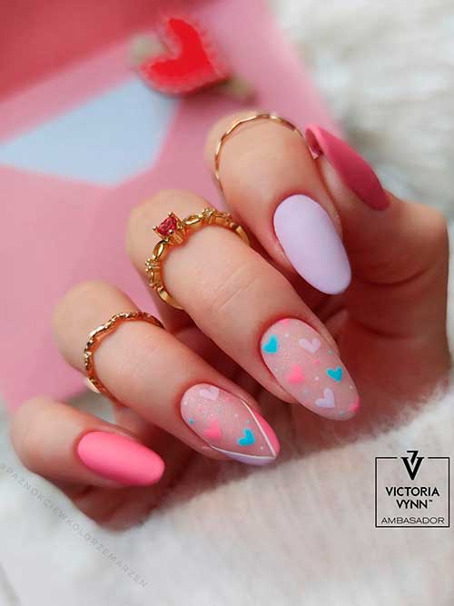 Pastel Valentines Nails Medium round shaped lavender and pink matte pastel valentines nails 2023 with heart shapes on two accent nails