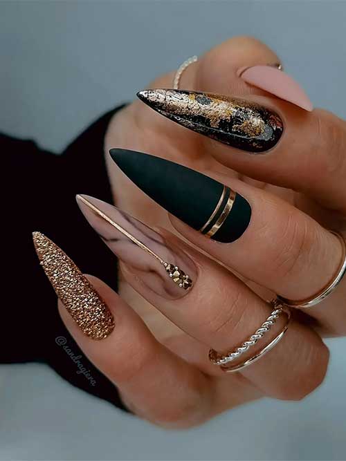 Pretty Long Stiletto Matte Nude and Black Nails with Gold Stripes, Glitter, Foil, and Rhinestones