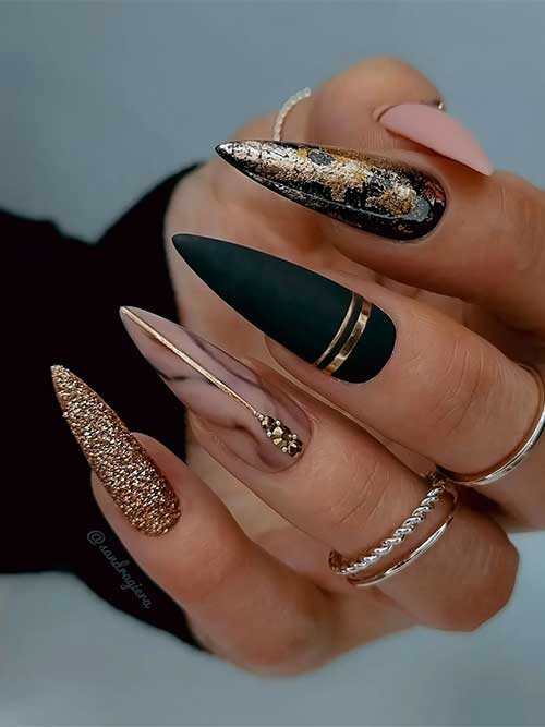 Pretty Matte Nude and Black Nails with Gold Decorations Pretty Long Stiletto Matte Nude and Black Nails with Gold Stripes, Glitter, Foil, and Rhinestones
