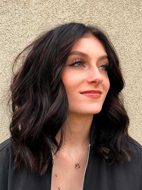 Wavy shoulder length hair with choppy layers adds volume and shape while waves add texture