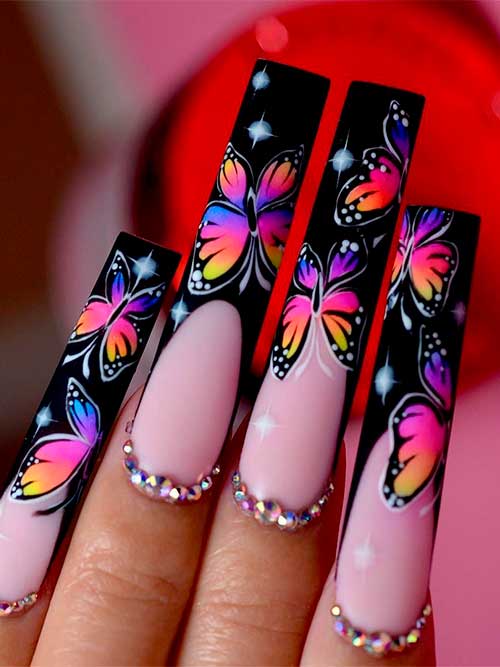 Long square-shaped black French tip nails with butterflies and rhinestones for spring 2023