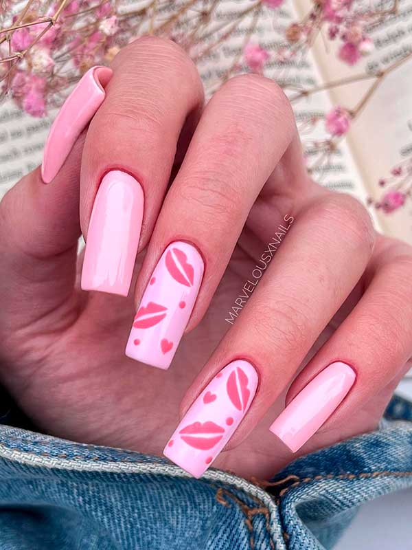 Long square shaped pastel pink valentines nails with bold kiss lips and small hearts