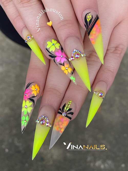 Long stiletto neon yellow ombre nails with flowers with rhinestones and black leaf nail art