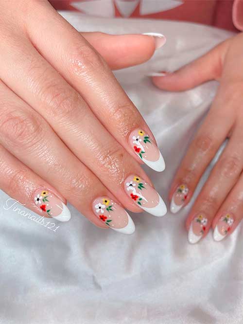 Medium almond-shaped white French nails with floral nail art for spring 2023