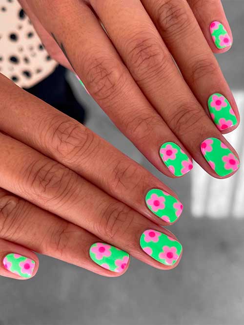Short pastel green spring nails with pink flowers