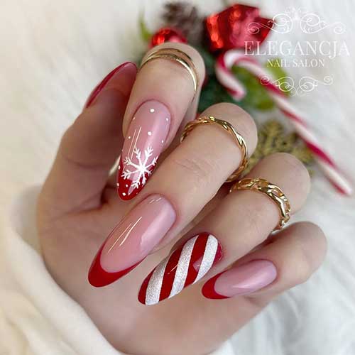 Long ALmond Shaped Christmas French Manicure with Red Tips, A Snowflake, and Candy Cane Accent Nails