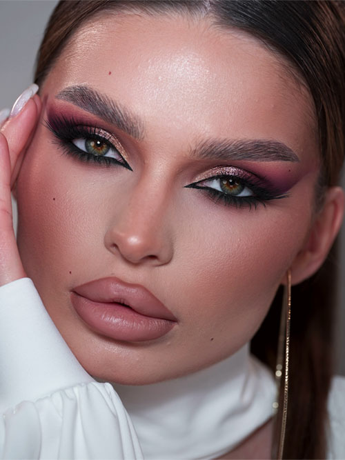Glamorous smokey eye makeup with pink, purple, and gold eyeshadows, bold liner, and soft pink lips. Glamorous smokey eye makeup with pink, purple, and gold eyeshadows, bold liner, and soft pink lips.