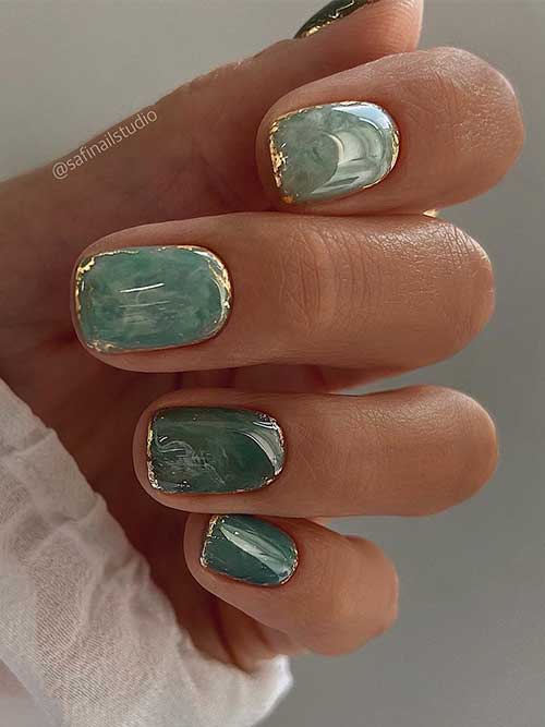 Green Short Nails with Marbling Effects and Gold Touches on the perimeter