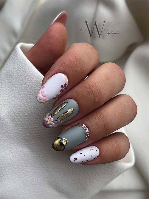 Medium almond-shaped white and gray nails for easter with floral nail art, bunny, and rhinestones