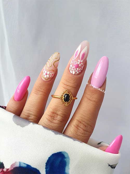 Pink Easter nail almond-shaped with flowers, bunny, and gold swirls