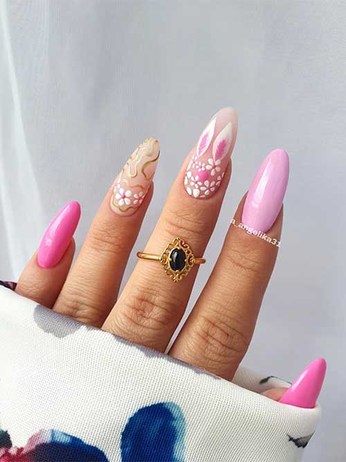 Pink Easter Nails Pink Easter nail almond-shaped with flowers, bunny, and gold swirls