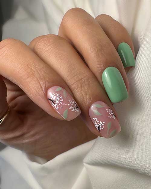 Short Green Nails with Flowers on Two Accent Nails for the Springtime