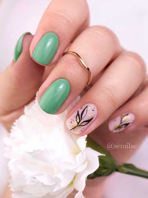 Short Green and Nude Pink Nails with Black Leaf Nail Art and Gold Glitter on Two Accent Nails