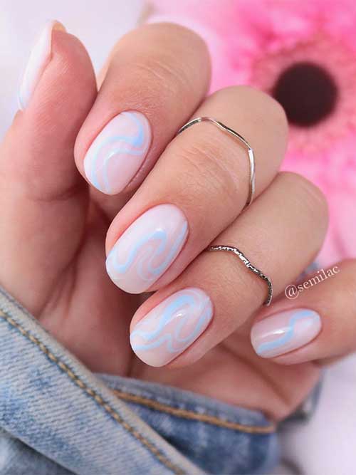 Short milky white nails with light blue swirl nail art