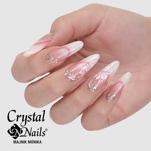 Long almond-shaped spring ombre manicure with a French tip twist, silver glitter, and floral nail art