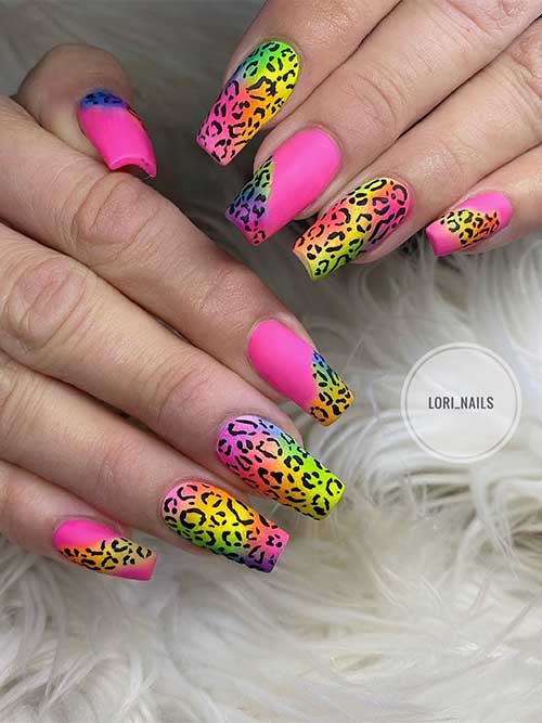 Coffin Matte hot pink with neon rainbow nails adorned with black leopard prints Coffin Matte hot pink with neon rainbow nails adorned with black leopard prints