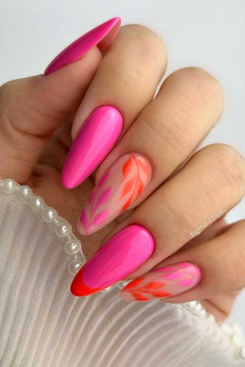 Long almond shaped hot pink and orange touches on French tip and leaf nail art