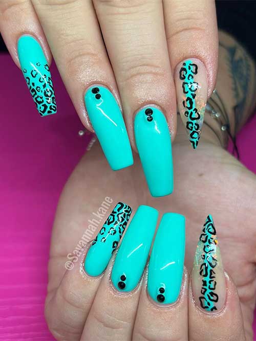 Long coffin aqua nails with black leopard prints and glitter on an accent stiletto nail