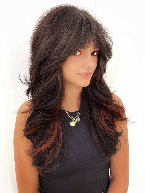 long shag haircut with bangs and layers which is one of the best long shaggy hairstyles for thick hair