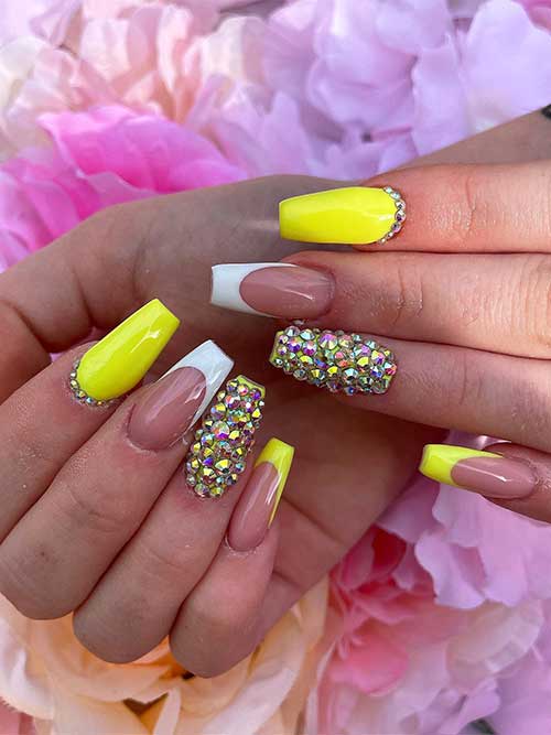 Long coffin bright yellow nails with rhinestones and an accent white French tip nail