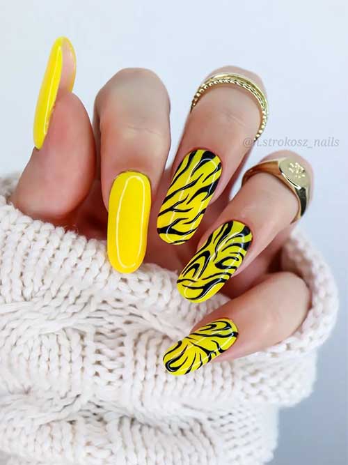 Long round bright yellow nails with zebra prints for summer 2023 Long round bright yellow nails with zebra prints for summer 2023