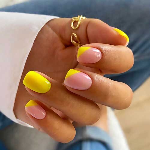 Short square bright yellow nails with diagonal French tips