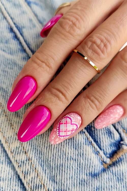 Almond hot pink Barbie nails with nude pink accents adorned with white patches and a heart shape Almond hot pink Barbie nails with nude pink accents adorned with white patches and a heart shape