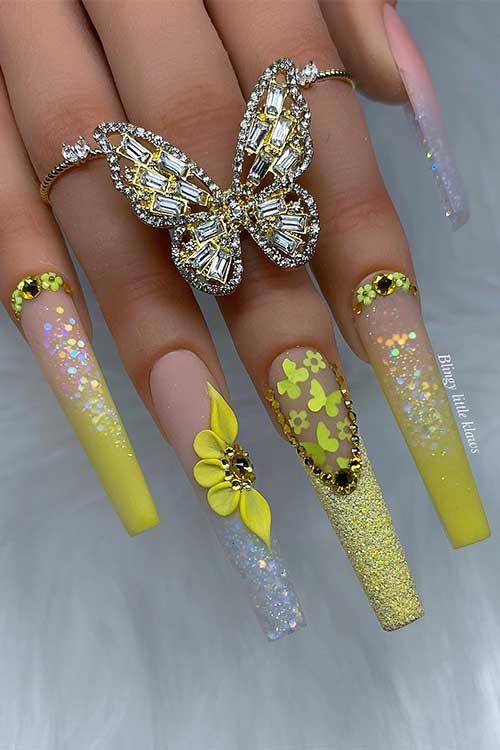 Long coffin ombre neon yellow acrylic nails with glitter, rhinestones, and flowers