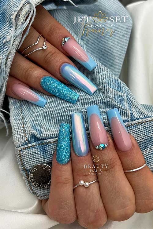 Long coffin-shaped light blue French tip nails with rhinestones and glitter and chrome two accent nails