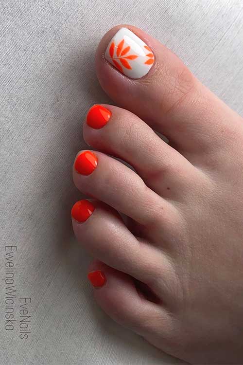 Neon orange summer toe nails with neon orange leaves on an accent off-white big toe