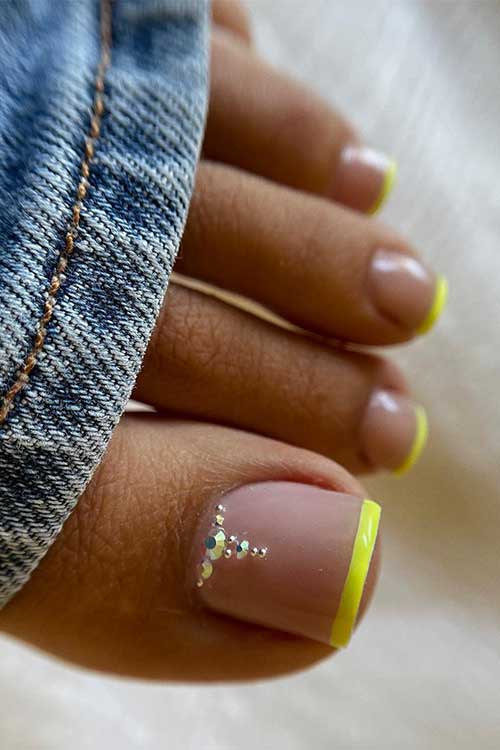 Neon yellow French summer toe nails with rhinestones 
