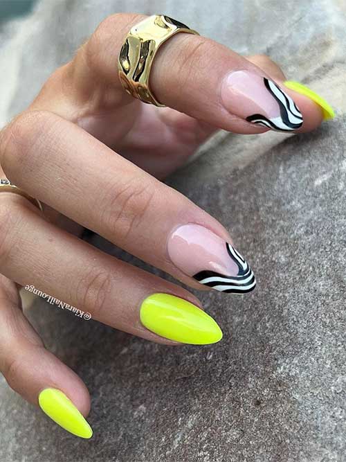 Short almond shaped neon yellow nails with two twisted black and white swirls as French tips