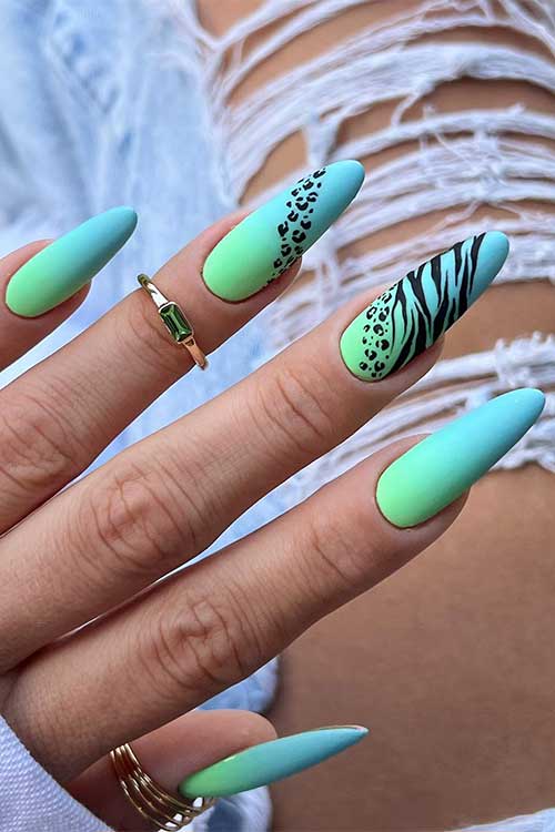 Long almond shaped matte mint green baby blue ombre nails with leopard and zebra prints on two accent nails