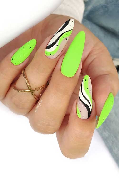 Long almond shaped matte neon green august nails with black speckles and black and white swirls