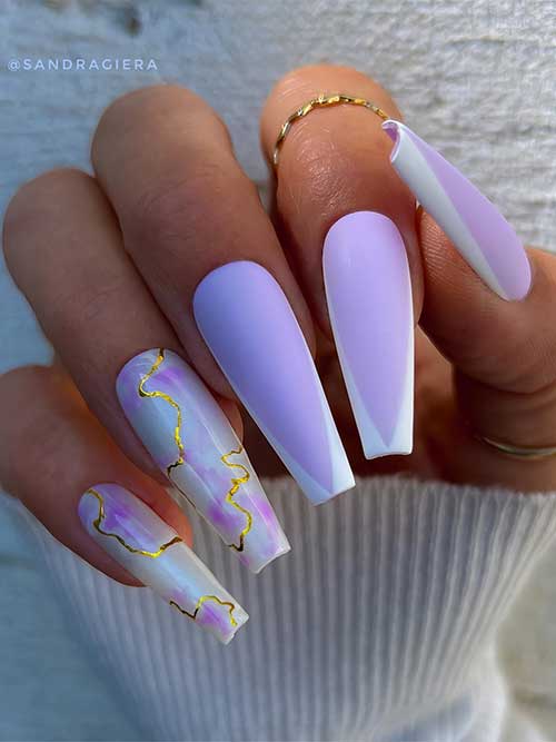 Long coffin matte lilac nails with white French tips and adorned with two glossy white lilac marble nails with gold marble veining