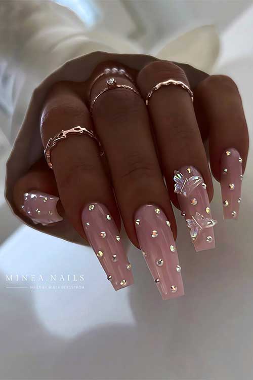 Long coffin nude pink fairy nails with rhinestones and transparent 3d butterflies on an accent nail