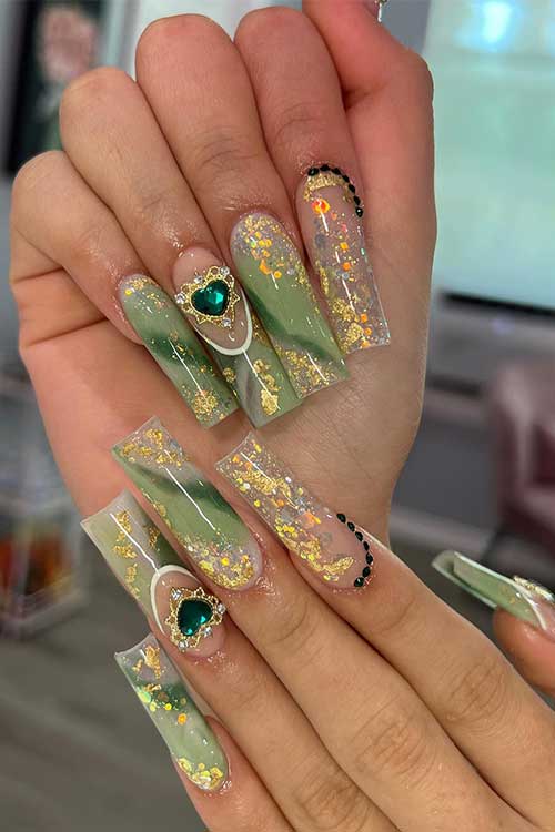 Long square shaped green marble fairy nails with gold glitter and a heart shaped jade gem