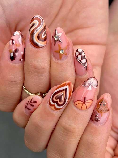 Autumnal funky nails feature different nail art such as a maple leaf, pumpkins, checkered, swirls, stars, and autumn leaves