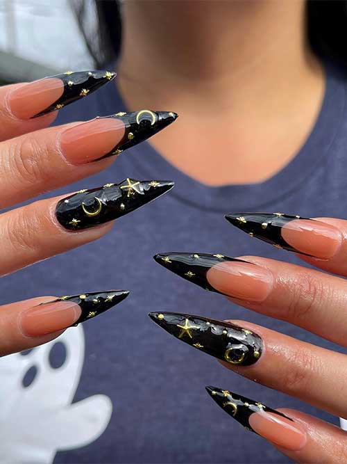 Black French Halloween nail design with gold celestial nail art.
