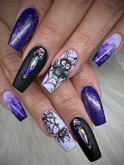 Dark purple and black Halloween nails with rhinestones, cobwebs, and bat nail art.