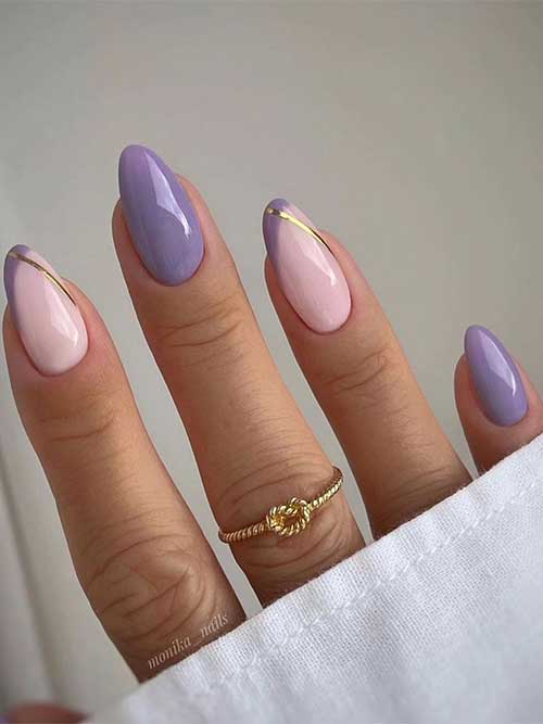 Dusty purple nails with two diagonal French tips adorned with a gold chrome stripe. Dusty purple nails with two diagonal French tips adorned with a gold chrome stripe.