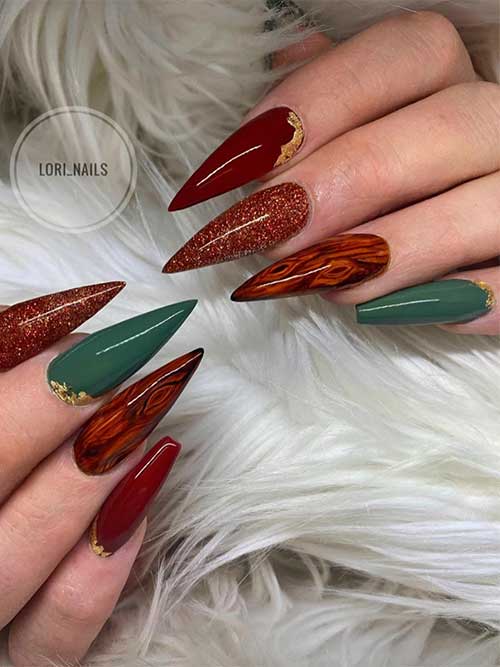 Edgy red and brown wood grain nails with an accent dark green nail adorned with a gold foil touch.