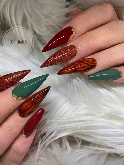 Edgy red and brown wood grain nails with an accent dark green nail adorned with a gold foil touch. Edgy red and brown wood grain nails with an accent dark green nail adorned with a gold foil touch.