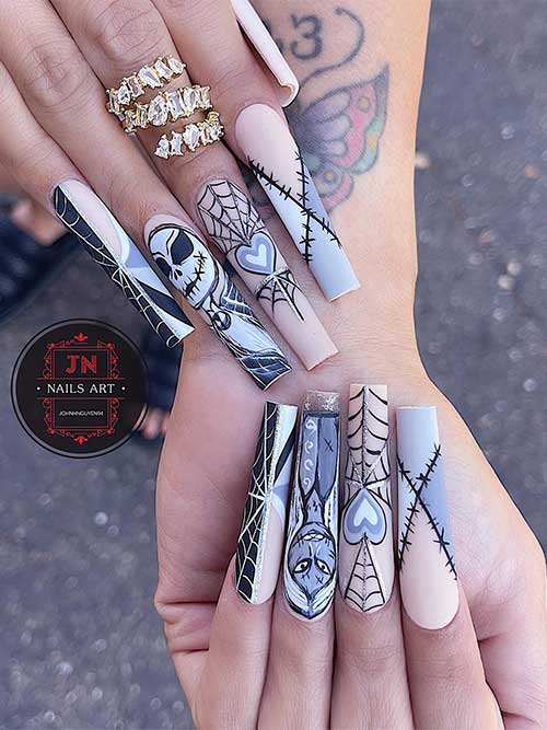 Long nude nails with black and gray various Halloween nail art designs.
