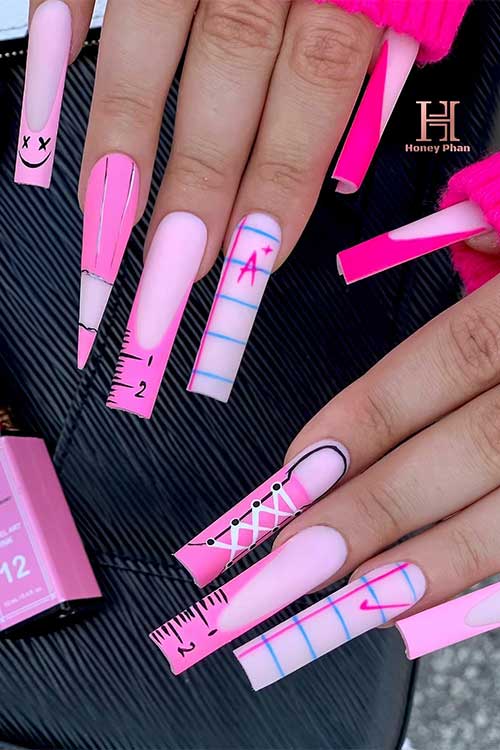 Long square-shaped matte Barbie pink French tip nails feature a ruler, notepaper, smiley face, and pencil stiletto accent.