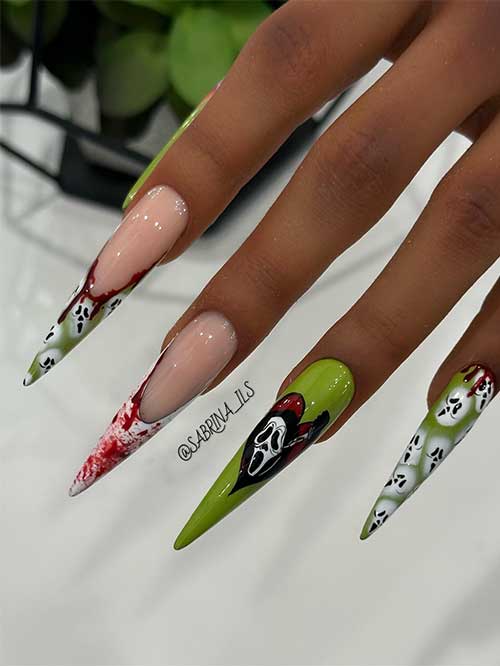 Long stiletto slime green Halloween nails feature blood splatter and scream faces Halloween nail art designs. 