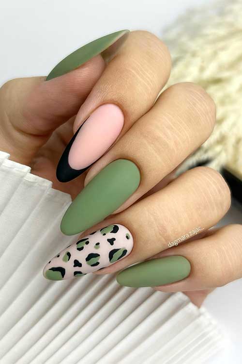 Matte Dark Green Nails in a highland green hue and adorned with black French and leopard accent nails. Matte Dark Green Nails in a highland green hue and adorned with black French and leopard accent nails.