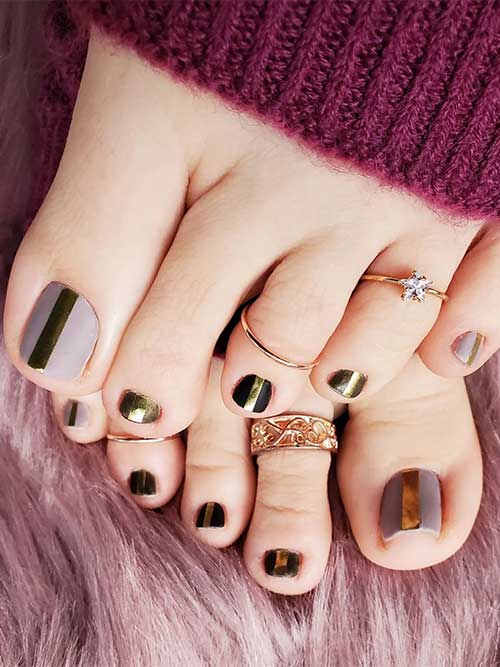 Matte brown and nude lilac fall toe nails with a centered gold strip on each toe nail