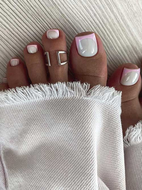 Modern light pink French tip toe nails over white base color.