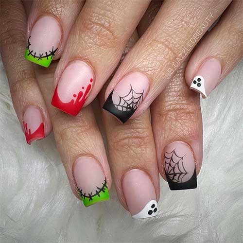 Multicolored short Halloween nails feature a cobweb, stitches, blood drip, and ghost Halloween nail art designs. Multicolored short Halloween nails feature a cobweb, stitches, blood drip, and ghost Halloween nail art designs.